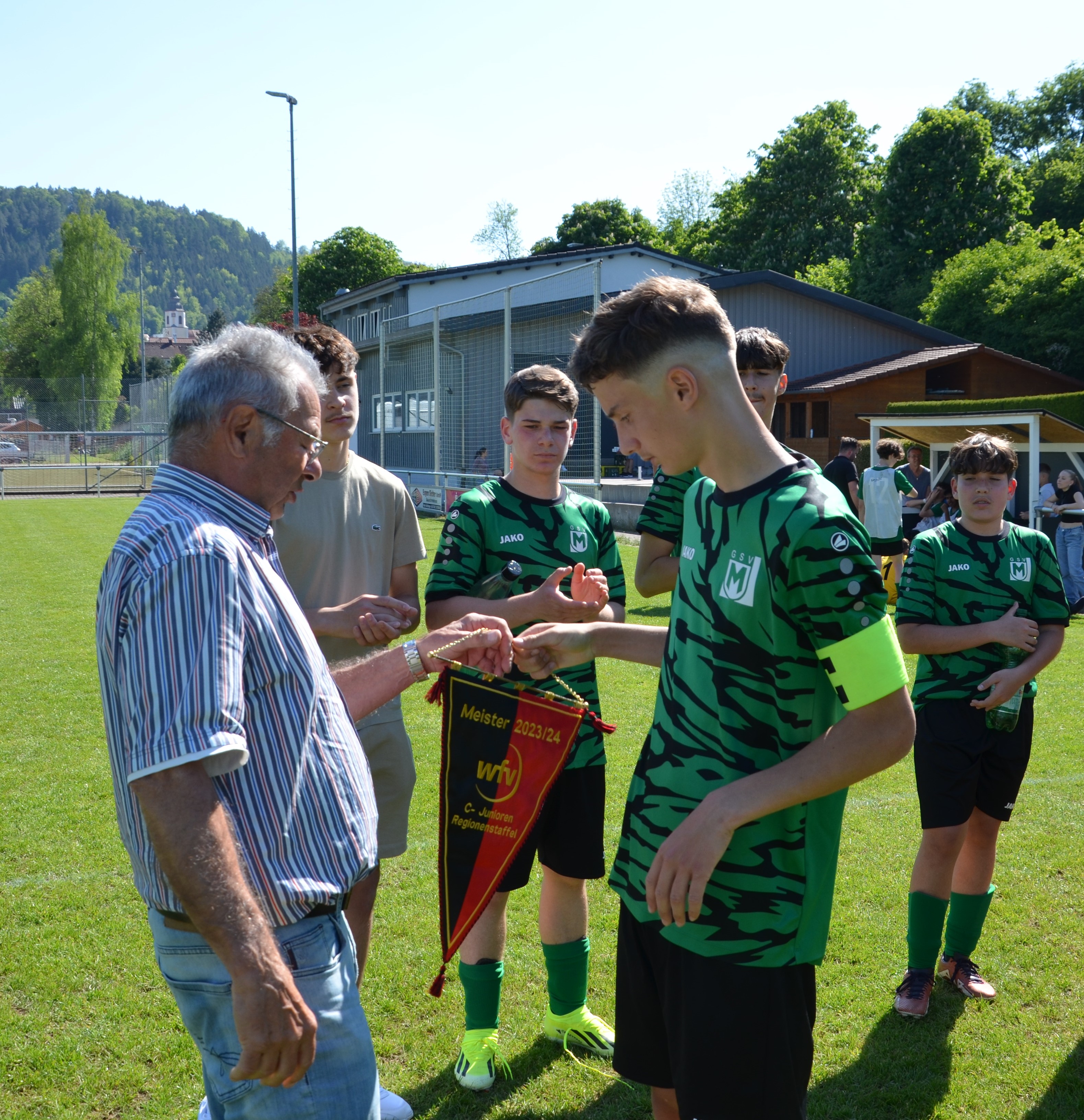 Finn Truttenbach, Kapitän der C1-Junioren des GSV Maichingen, bekommt von Staffelleiter Norbert Bremer den Meisterwimpel überreichtBild: z