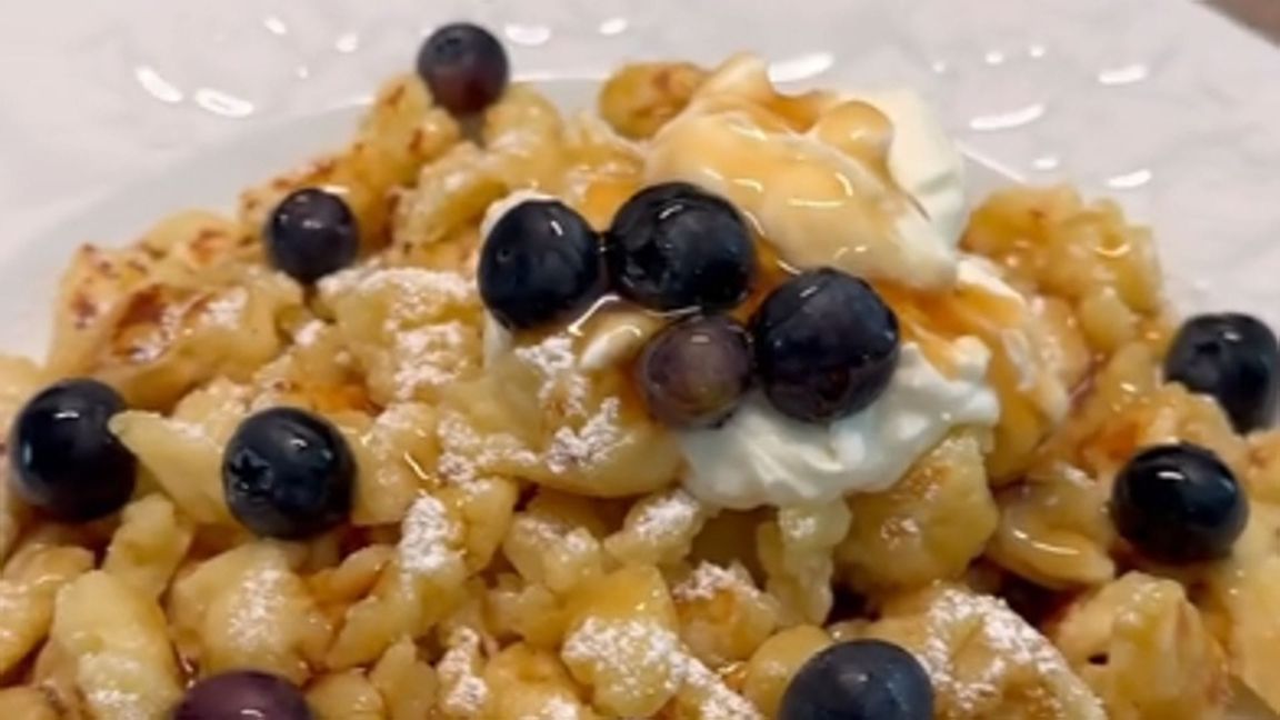 Die Amerikanerin serviert die „Scrambled Pancakes“ mit Puderzucker, Sahne, Sirup und Blaubeeren.