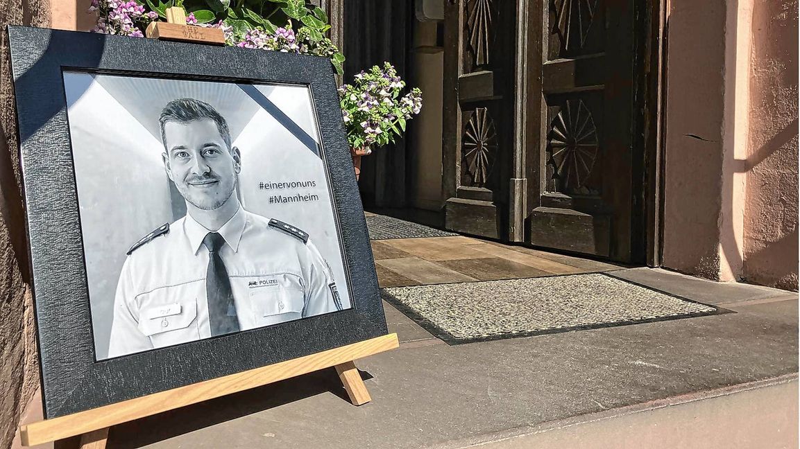 In einem Restaurant in der Kleinstadt steht am Eingang das Bild des bei einem Messerangriff getöteten Polizisten.