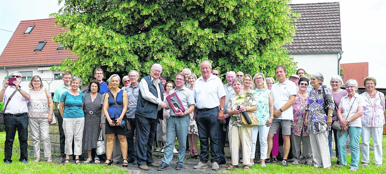 Mit Getränk-Geschenk in der Hand dankt Ortsvorsteher Wolfgang Stierle Karlheinz Arnau für 51 historische Spaziergänge durch Maichingen. Rechts neben Stierle Walter Arnold, der künftig durch den Flecken führt. Bild: Heiden