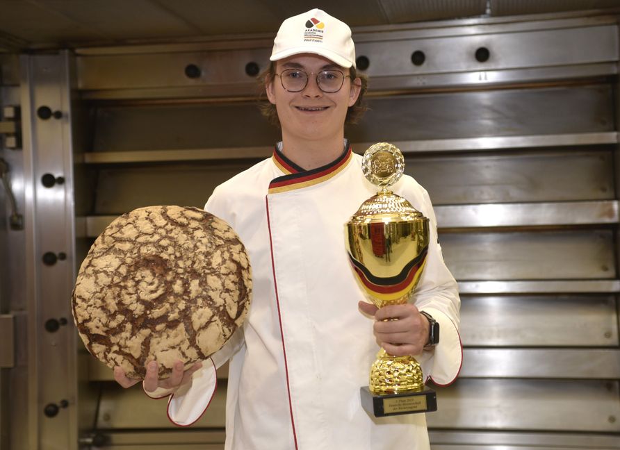 Max Baier, Deutscher Meister der Jung-Bäcker mit dem Siegerpokal und einem Laib Roggenbrot aus der heimischen Backstube. Bild: Reichert