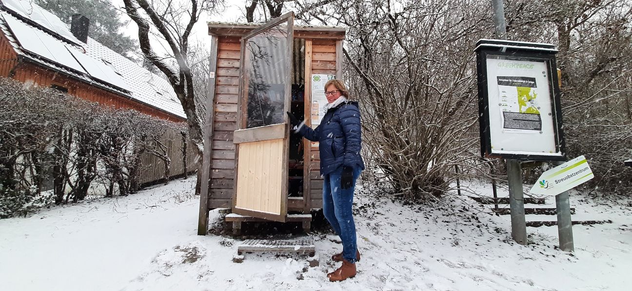 Karola Wunderlich freut sich darüber, dass die Türe des Koscht-Nix-Häusles wieder intakt ist - dank eines unbekannten Wohltäters.  Bild: Elbers