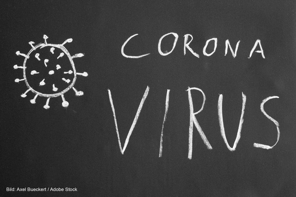 Corona virus hand-drawn text and simple illustration with chalk on blackboard