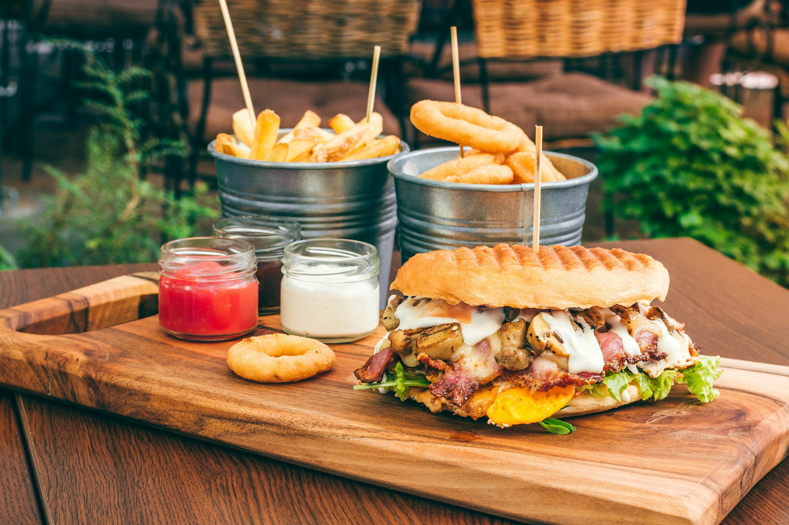 Tasty grilled beef burger with salads, egg, mushrooms, and bacon.