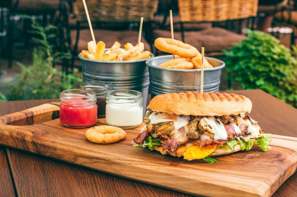 Tasty grilled beef burger with salads, egg, mushrooms, and bacon.