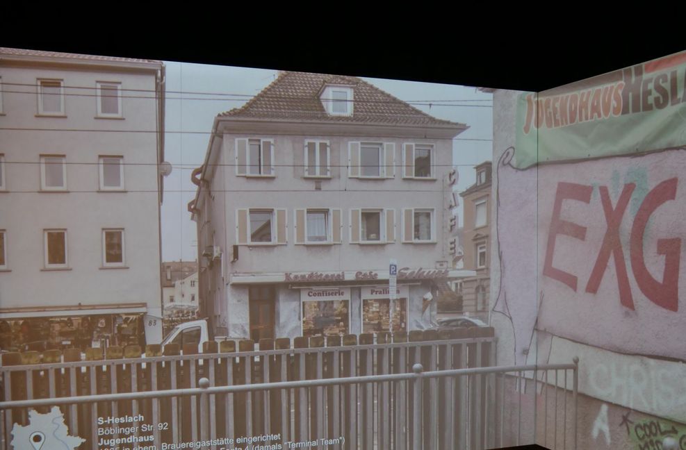Im sogenannten Projektionsraum läuft eine Bilder-Show. Die Panorama-Fotos bekleiden drei Wände, so dass man das Gefühl hat, tatsächlich inmitten längst  verschwundener Bauten und Räume zu stehen. Hier zu sehen das Jugendhaus Heslach in der Böblinger Straße.  Auch die Bühne  hat Heiko Stachel fotografiert: Dort haben die Fantastischen Vier 1988 ihr erstes Live-Konzert gegeben, damals hießen sie noch Terminal Team. Heiko Stachel hat viele solcher Stuttgarter Stadtgeschichten-Highlights parat.