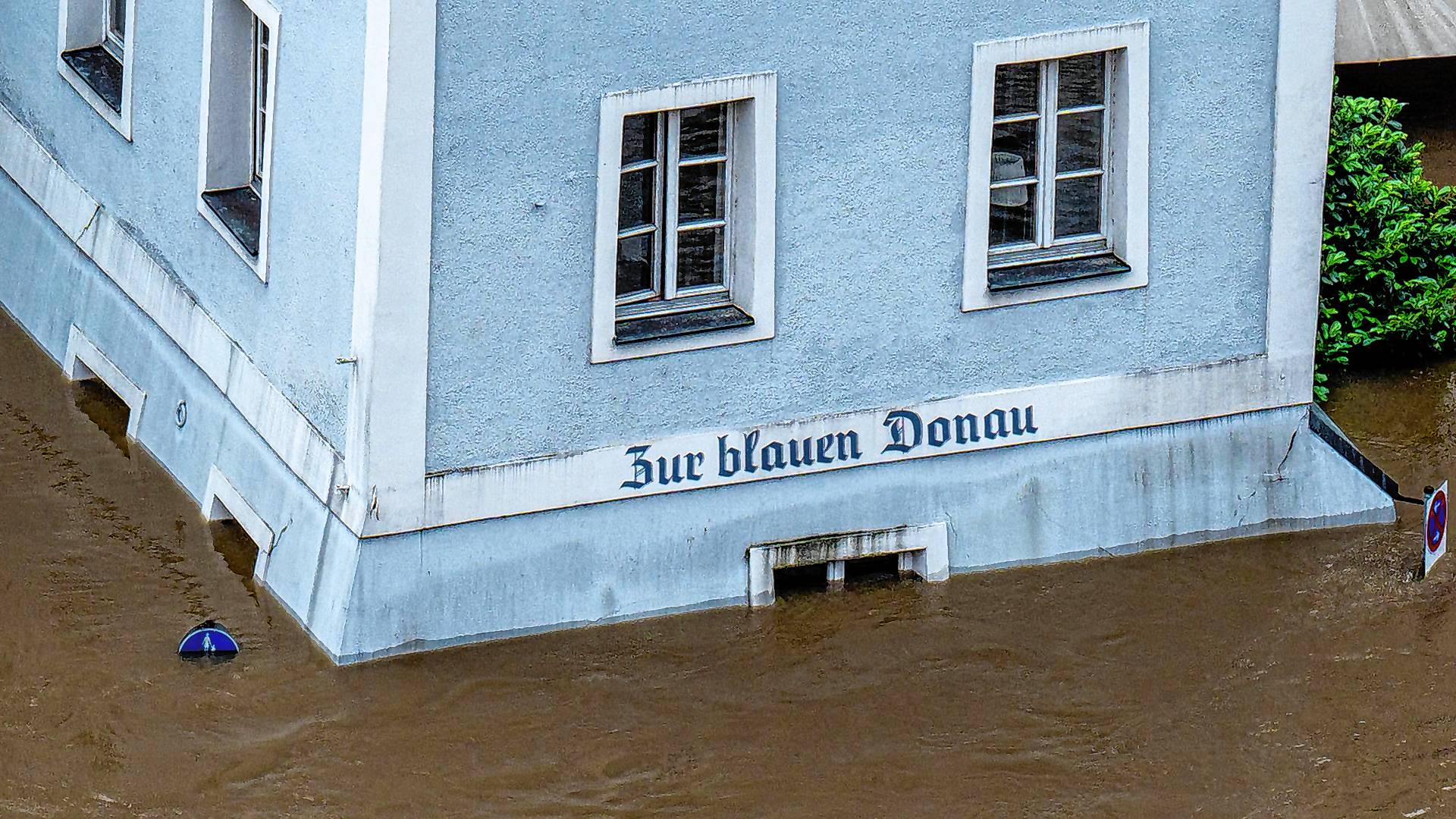 Ein Haus mit dem Schriftzug "Zur blauen Donau" im Hochwasser der Donau.