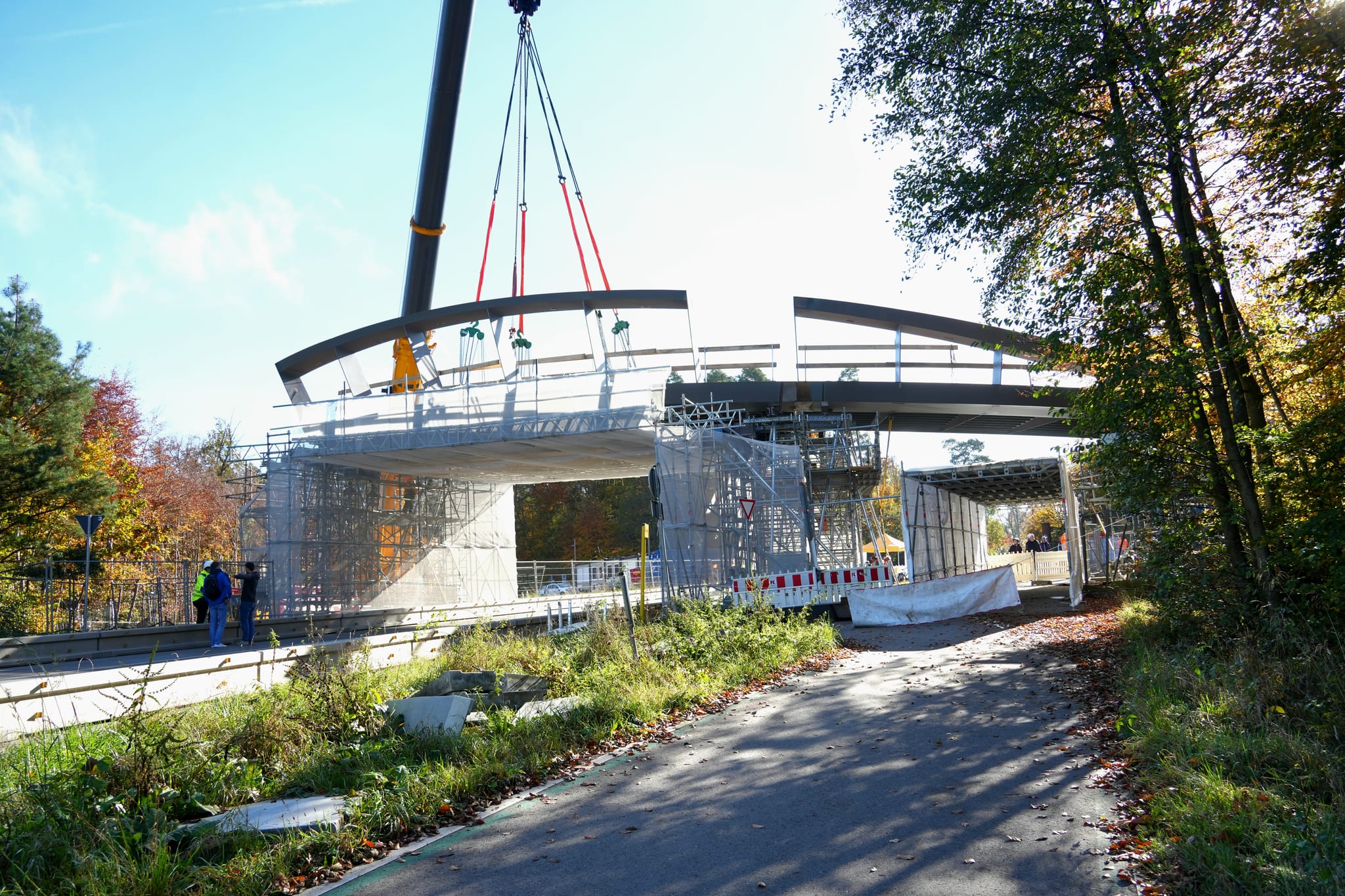 Die neue Radweg-Brücke wird an ihren Platz über der Panzerstraße gehoben.