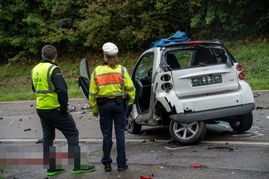 Die beiden Helfer stehen fassungslos vor dem völlig demolierten Smart des 21-jährigen Fahrers. Bild: SDMG/Dettenmeyer