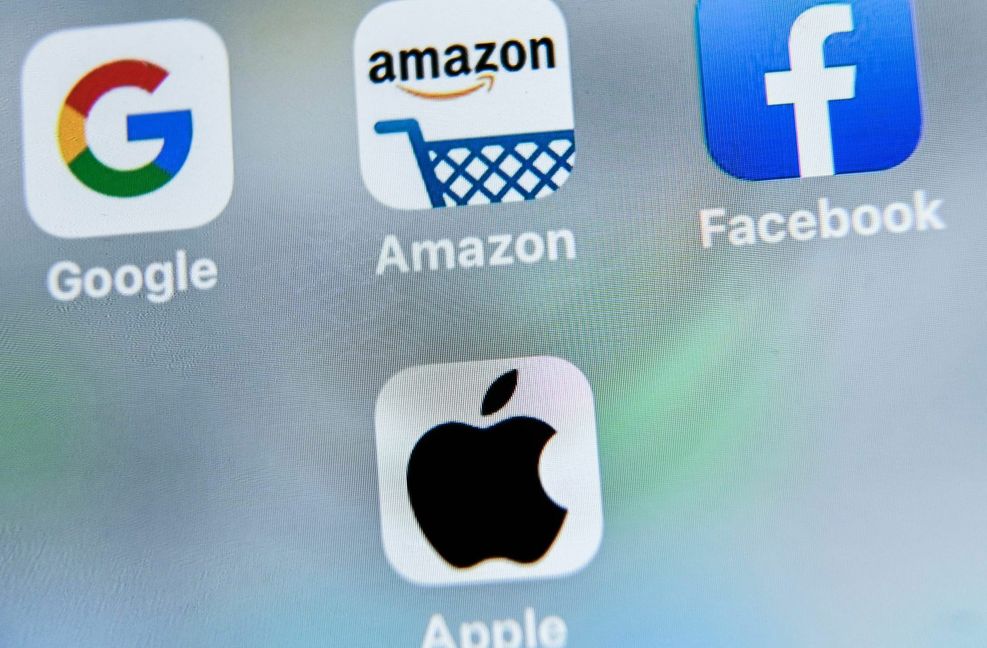 Apps von Google, Amazon, Facebook und Apple auf einem Handy. Die EU-Kommission möchte die Macht der großen Internet-Plattformen begrenzen. Foto: AFP/Denis Charlet