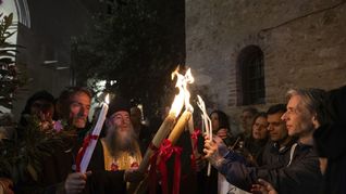 Orthodoxe Christen geben in Athen das Osterfeuer weiter. Der Brauch zählt zu den Höhepunkten ihres Osterfests und wird in der Nacht von Karsamstag auf Ostersonntag gefeiert.