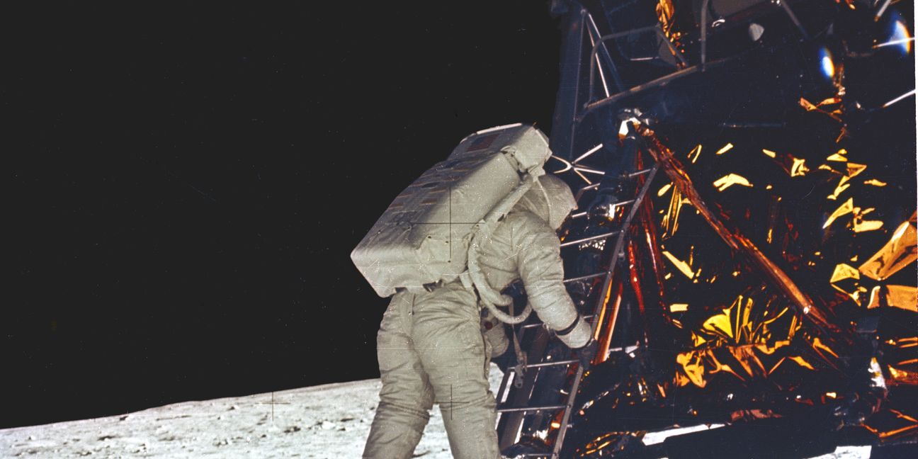 APOLLO 11 ONBOARD PHOTO:  ASTRONAUT ALDRIN MAKES FIRST STEP ONTO THE SURFACE OF THE MOON.