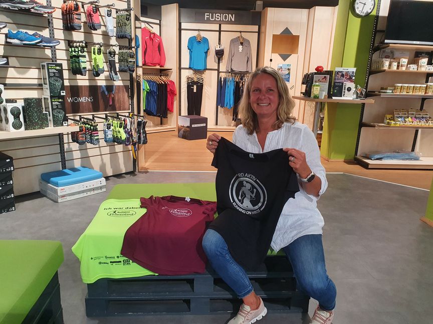 Neon für die Männer, bordeauxrot für die Frauen und das schwarze Sondershirt für das große Daimler-Team: Karen Stahl packt schon mal die Lauf-Hemden aus. Bild: Wegner