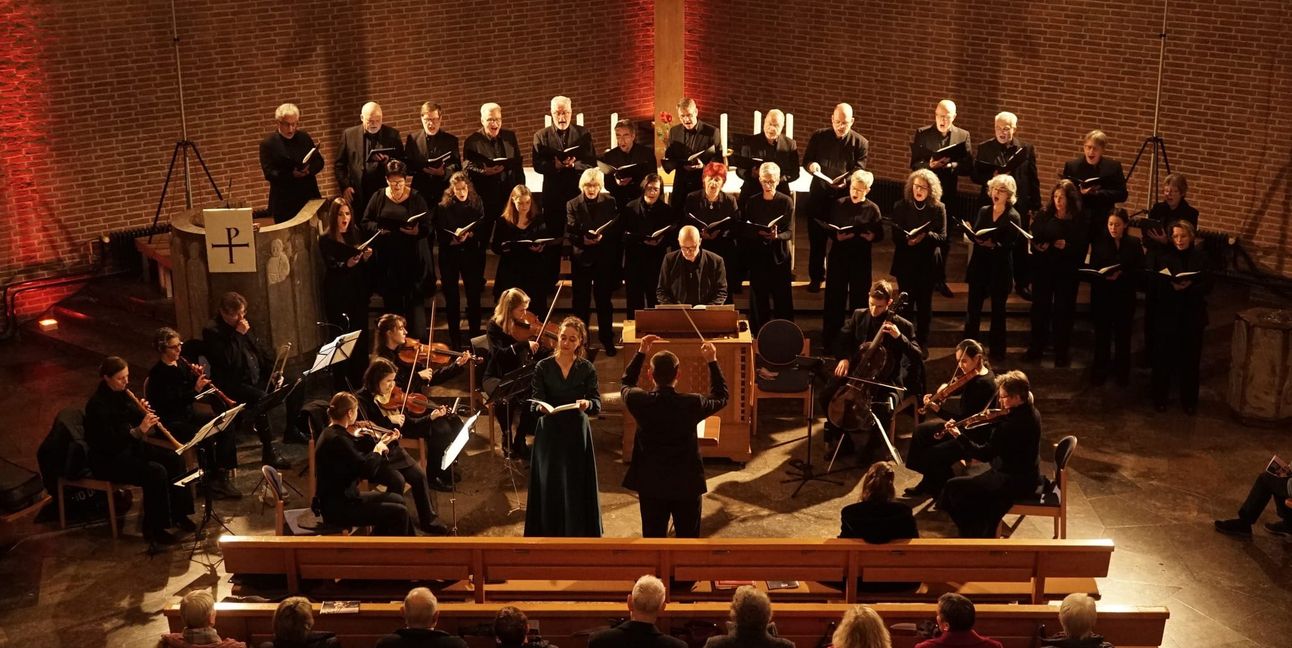 Der Kammerchor bei seinem Gloria-Konzert mit Solosopranistin Natalie Beck neben Dirigent Homolka.