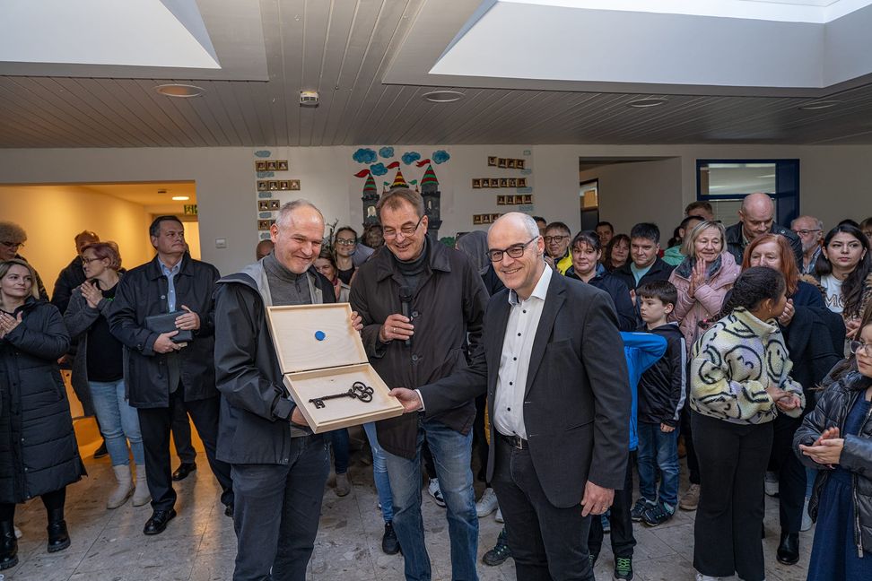 Ein Schlüssel und ein Schließ-Chip für Bürgermeister Martin Thüringer (rechts) von den beiden Architekten Elmar König (links) und Stefan Schwab. Bild: Richter