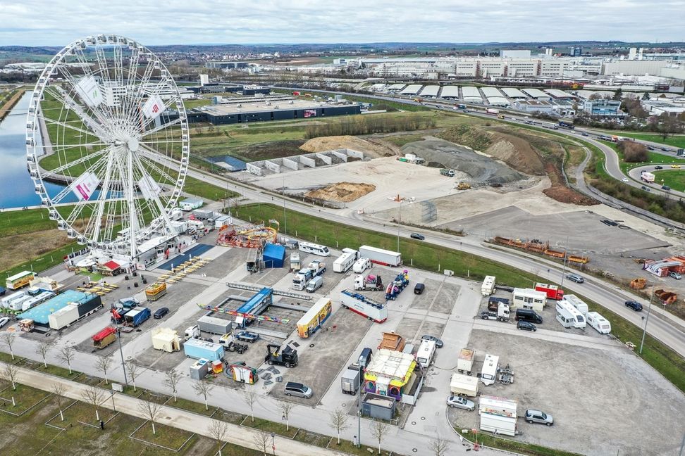 Das Riesenrad bekommt Zuwachs: Der Oster-Rummel wird aufgebaut. Bild: Dettenmeyer