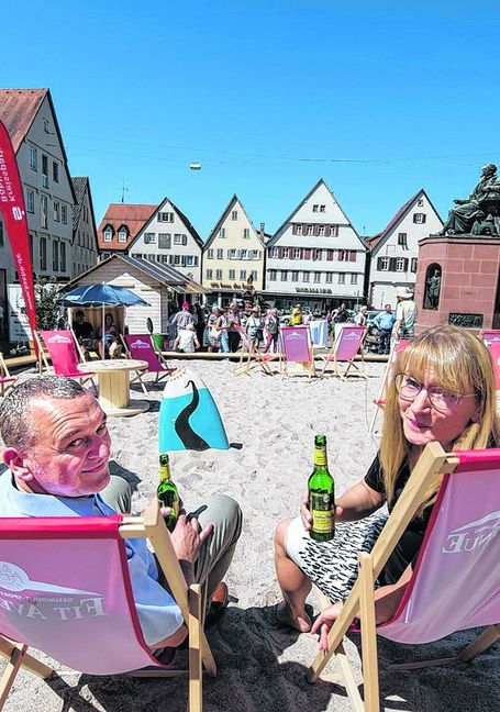 Bürgermeister Thilo Schreiber und City-Managerin Marion Beck genießen den Strandsommer auf dem Marktplatz in Weil der Stadt. Bild: Richter/A