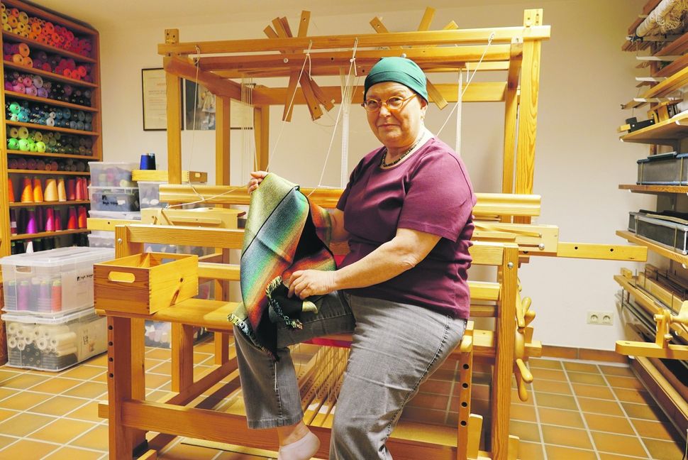 Das Foto zeigt Brigitte Bilfinger in ihrer Werkstatt mit einem vom Wilhelma-Tukan inspirierten Schal. Mit etwas Glück bekommt sie im Oktober zum zweiten Mal den Landes-Staatspreis verliehen. Bild: Heiden