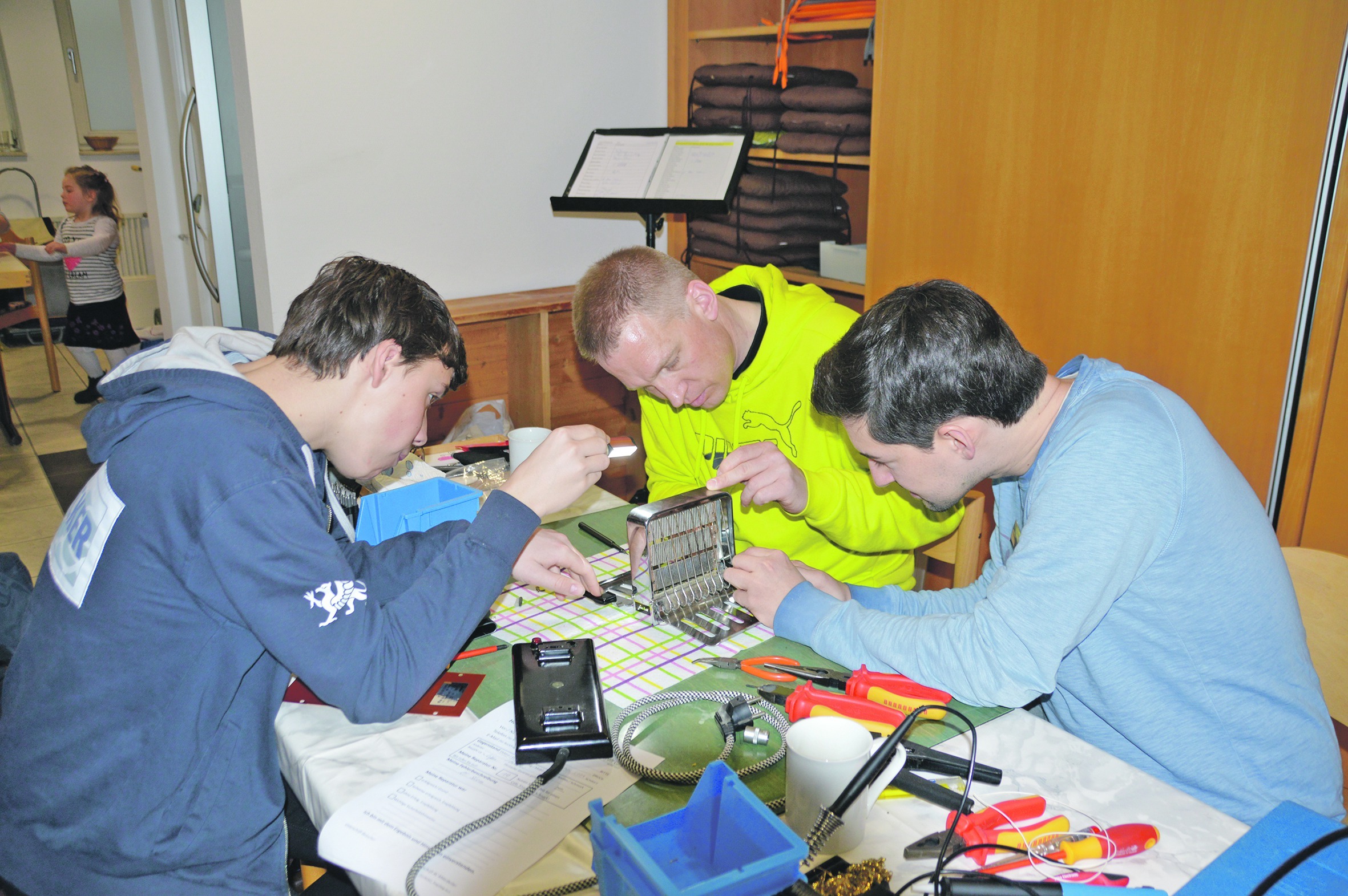 Tilmann Schöck und Uli Kleemann suchen mit Besucherin Helene Hein nach der Ursache, weshalb sich das Fach ihres CD-Spielers nicht mehr öffnet.