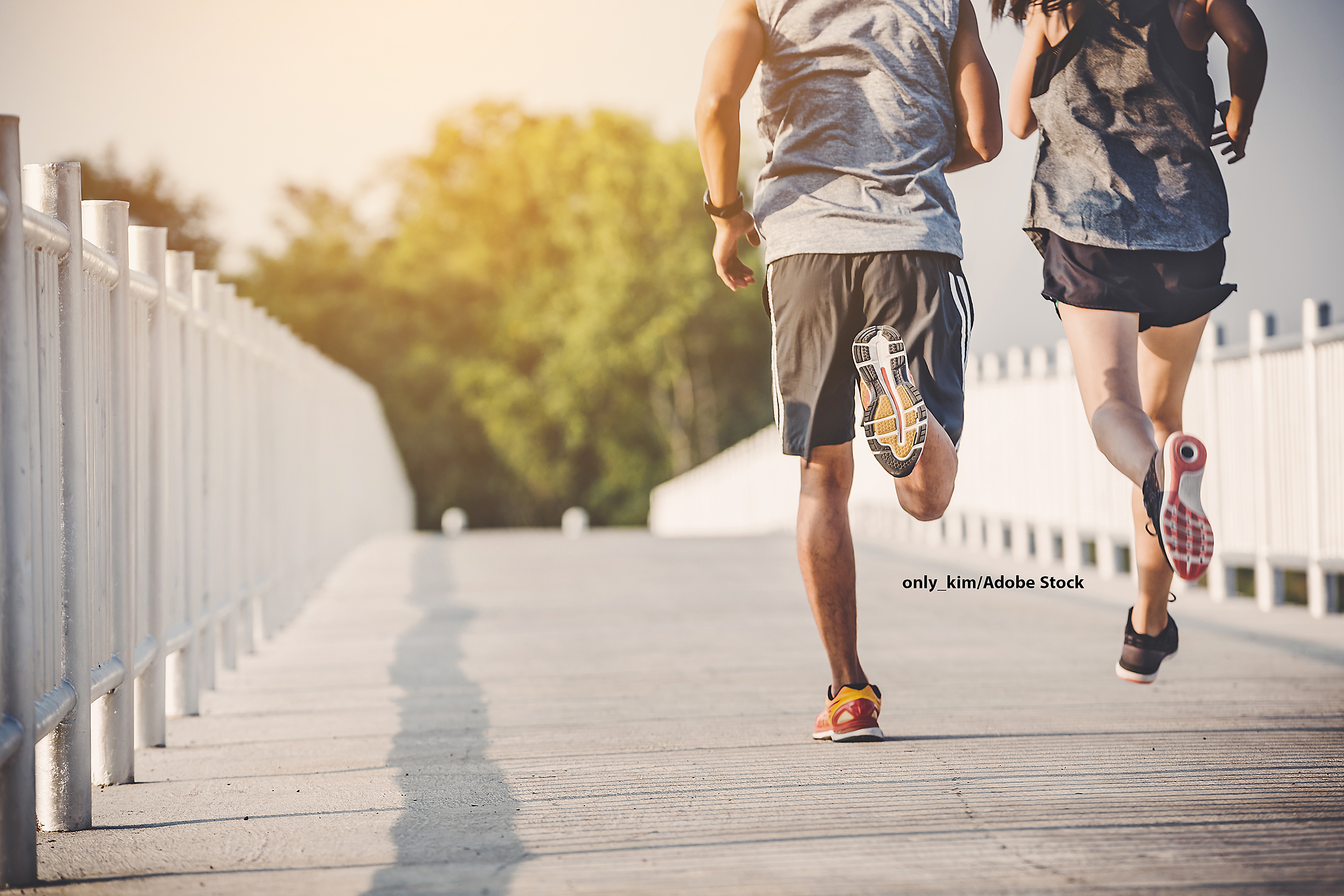 young couple runner running on running road in city park
 247720489