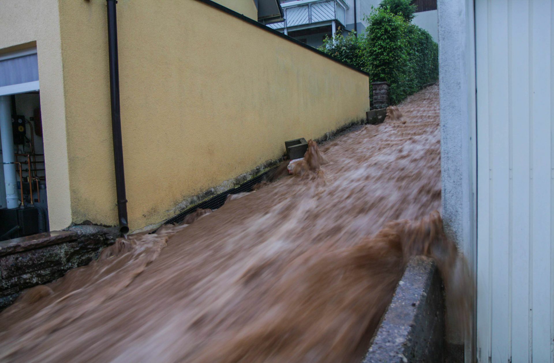 Braune Wassermassen rauschen im baden-württembergischen Altensteig über eine Treppe nach unten nach heftigen Unwettern.
 Foto: Aaron Klewer/Einsatz-Rep..