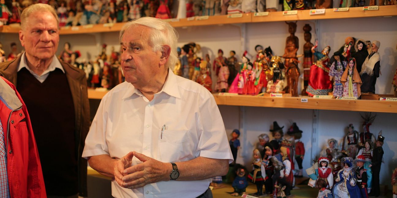 Auf unserem Foto ist Pfarrer Franz Pitzal (im weißen Hemd) zu sehen, im
Hintergrund seine Puppensammlung.   Bild: Cakir