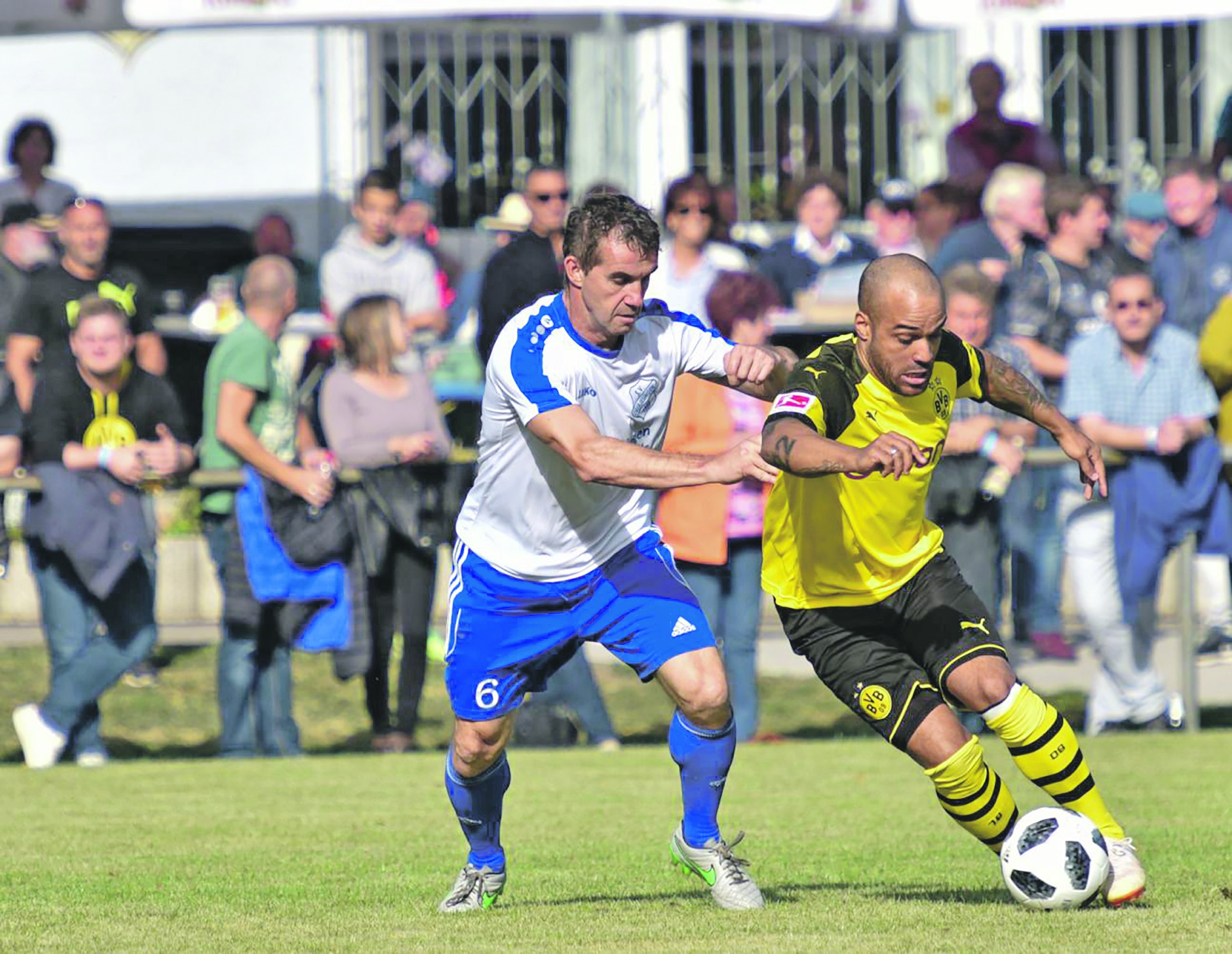 Andi Paulus (links) versucht, den flinken Ex-Nationalspieler David Odonkor zu stoppen. Der Auftritt der Dortmunder Traditionself in Oberjesingen war ein Fußballfest.  Bild: Tatjana Vecsey