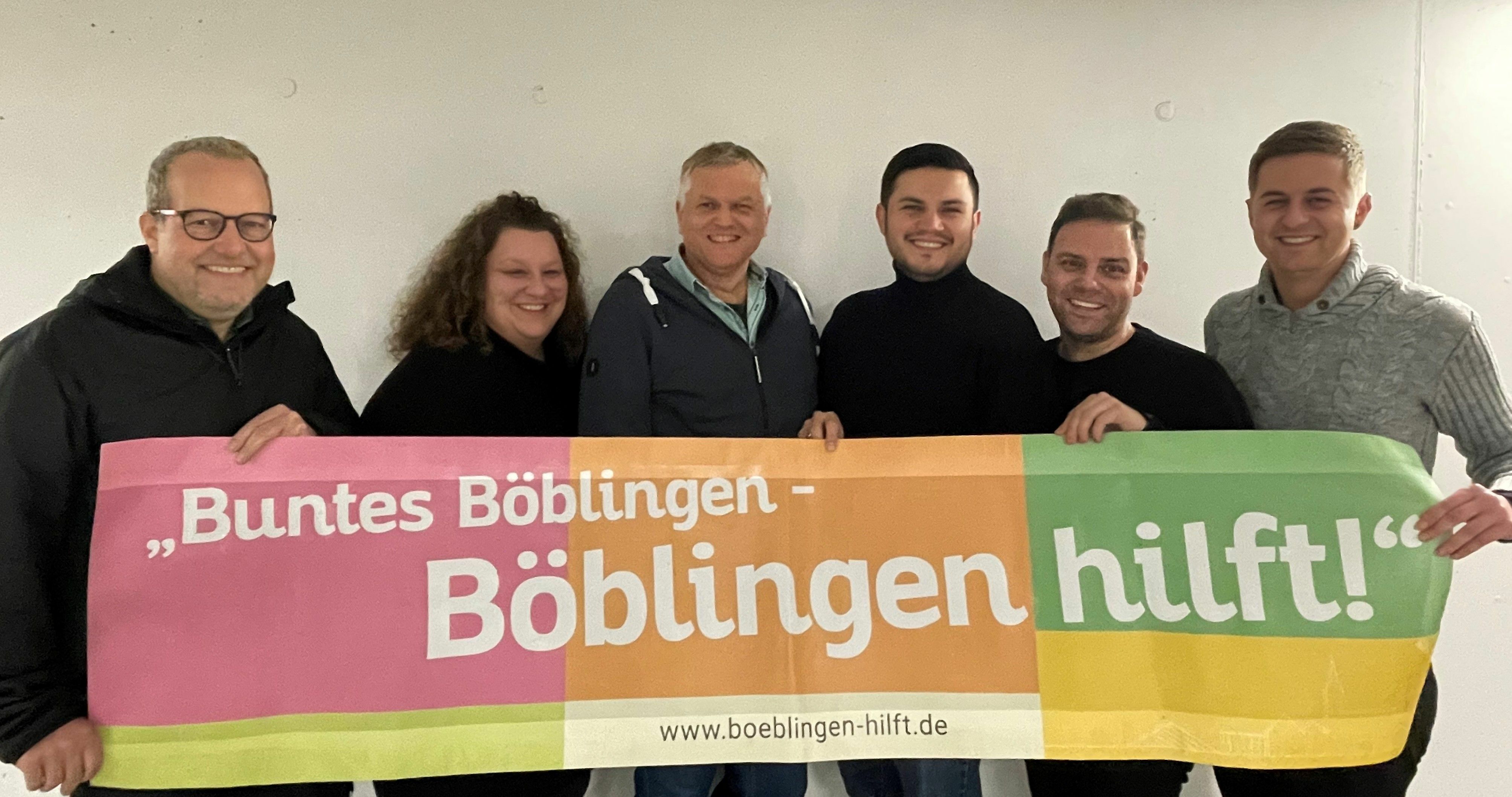 Das Organisationsteam von „Buntes Böblingen“ mit dem Banner aus der Zeit der Corona-Pandemie, als sie Alltagshilfe organisiert haben. Von links: Manuel Zimmerer, Hannah Behm, Markus Helms, Olcay Miyanyedi, Florian Wahl, Lukas Häberle. Bild: z