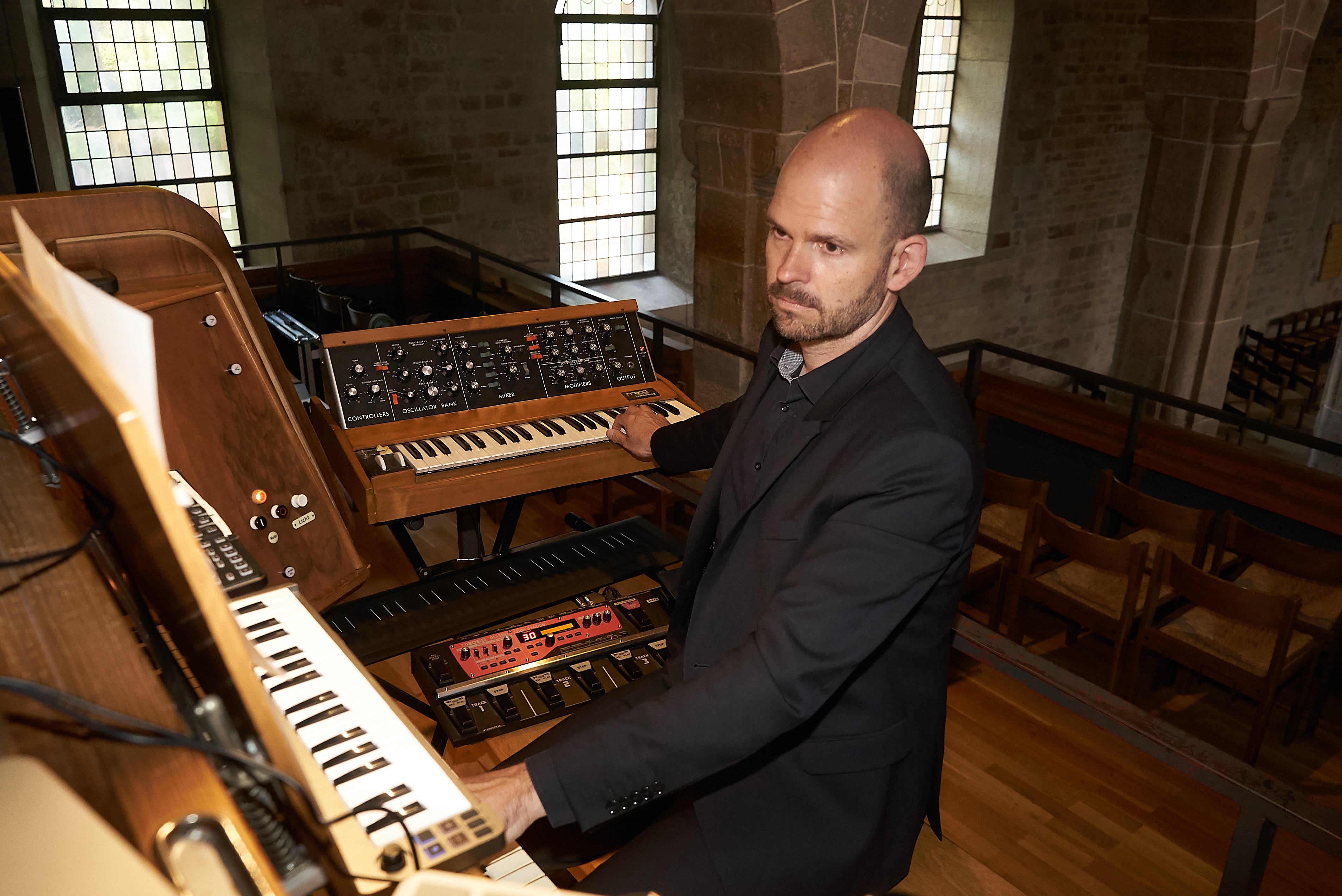 Organist, Pianist und Komponist Sebastian Bartmann spieplt in der der Sindelfinger Martinskirche an Synthesizer und Weigle-Orgel.    Bild: Heiden