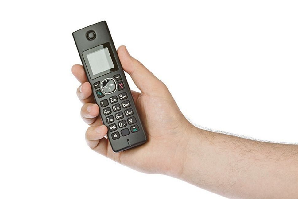 Hand with wireless radio telephone isolated on white background