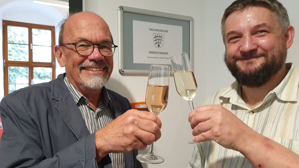 Helmut Hofmann (links) stößt als als stellvertretender Sindelfinger Oberbürgermeister mit Torgaus Jugendherbergs-Vater Thomas Grosch-Pfütze auf den neuen „Tagungsraum Sindelfingen“ an.      Bild: Wegner